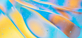 Close up digital illustration of blue, yellow, orange and pink thick liquid